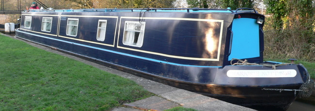 The narrow boat travelling through a lock on the canal
